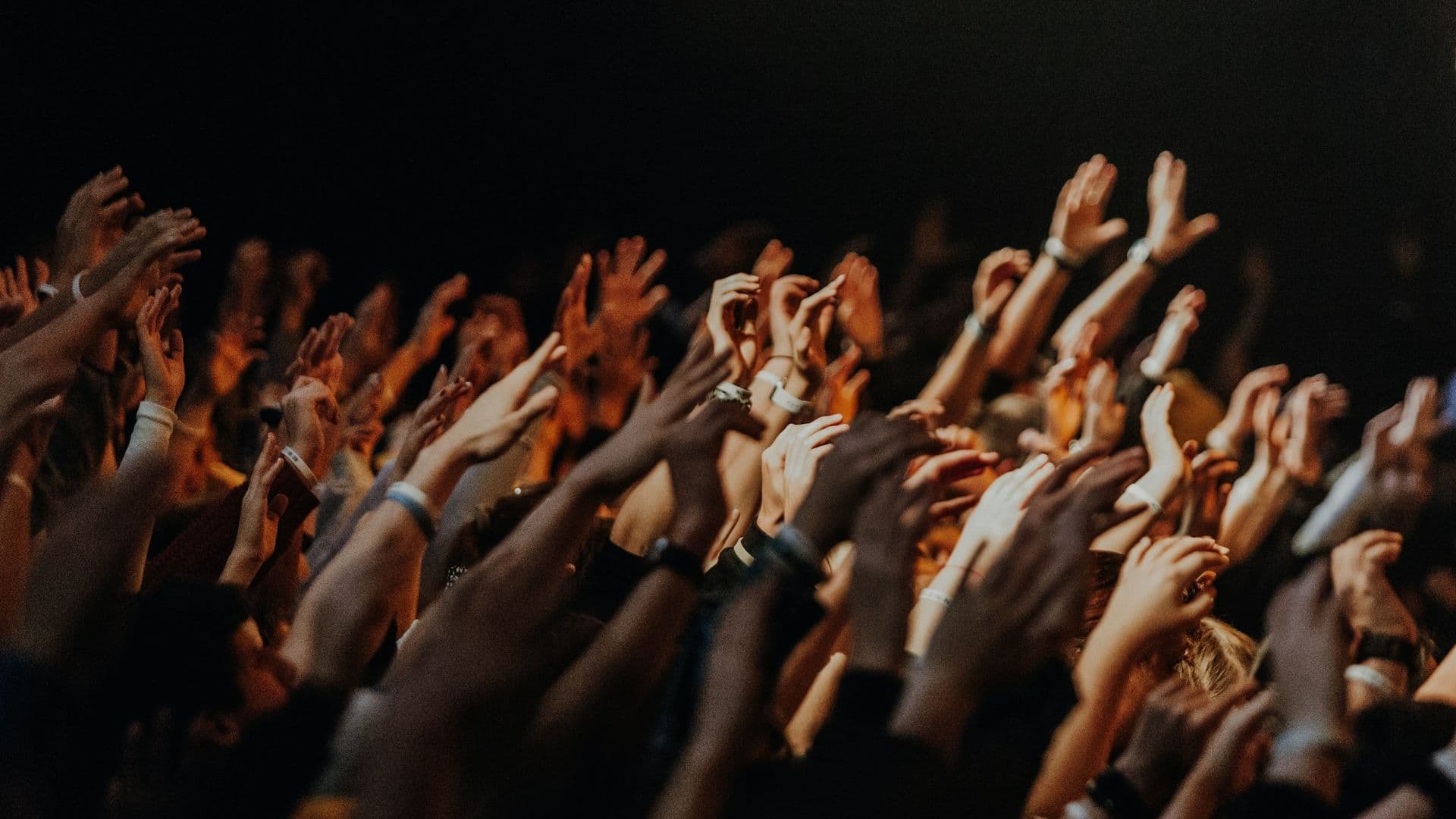 People raising their hands during a worship gathering