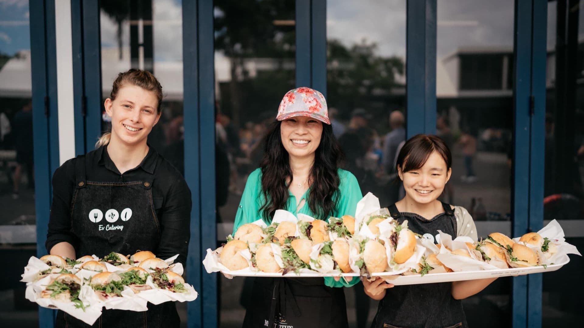 Ev catering volunteers holding trays of food