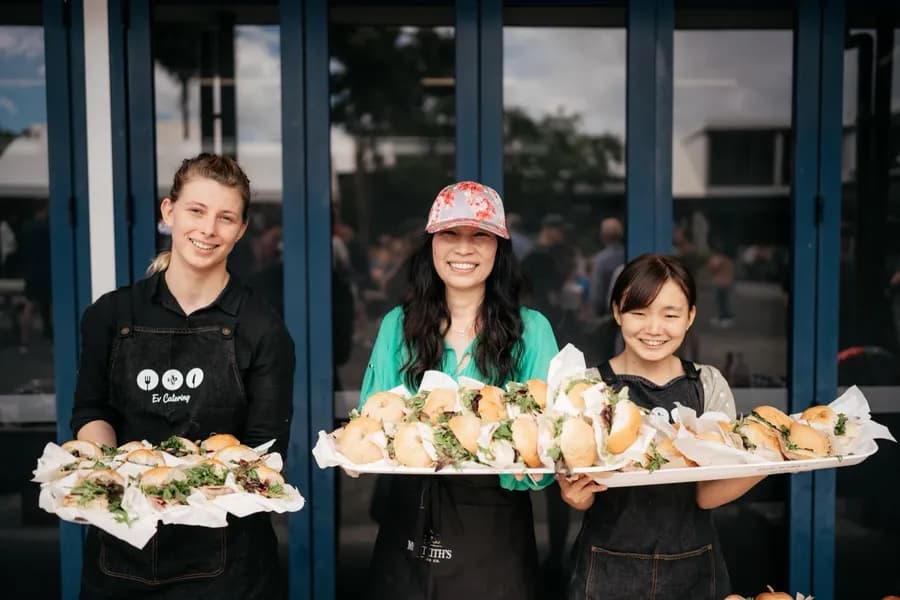 Ev catering volunteers holding trays of food